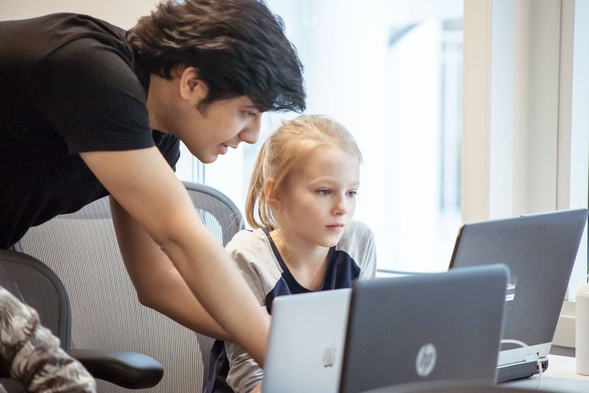 Rafid helping a student with coding